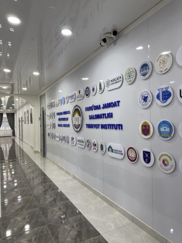 FMIPH corridor with university emblems and branding